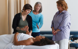 massage therapist student performing massage with professor