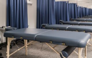 tips-to-find-a-great-used-massage-table-massage-tables-lined-up-at-east-west-college-oth-the-healing-arts-portland-oregon